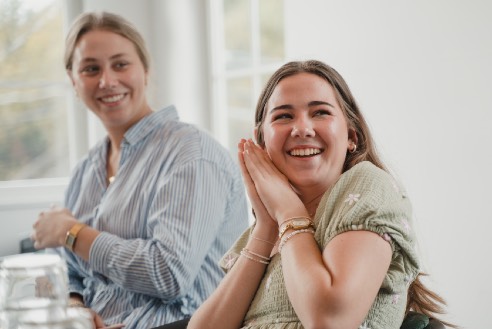 Two members of the LeapYear community smiling together